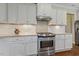 Modern kitchen featuring white cabinets, granite countertops, and stainless steel appliances at 624 Meadowgrass Ln, Wake Forest, NC 27587