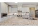 Well-lit kitchen featuring granite countertops, stainless steel appliances, and white cabinetry at 624 Meadowgrass Ln, Wake Forest, NC 27587