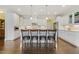 Bright kitchen featuring white cabinetry, granite counters, stainless appliances, and island with seating at 624 Meadowgrass Ln, Wake Forest, NC 27587