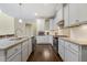 Bright kitchen with stainless steel appliances, white cabinetry, granite countertops, and wood flooring at 624 Meadowgrass Ln, Wake Forest, NC 27587