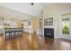 Bright, open-concept living room featuring a fireplace, kitchen, and hardwood floors at 624 Meadowgrass Ln, Wake Forest, NC 27587