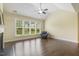 Living room with large windows offering abundant natural light and hardwood flooring at 624 Meadowgrass Ln, Wake Forest, NC 27587