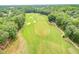 Expansive aerial view of a lush green golf course with meticulously placed sand traps at 7304 Hasentree Club Dr, Wake Forest, NC 27587