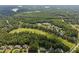 Aerial view of a golf course community surrounded by lush greenery and scenic lakes at 7304 Hasentree Club Dr, Wake Forest, NC 27587