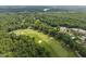 Aerial view of a golf course community surrounded by lush greenery and scenic lakes at 7304 Hasentree Club Dr, Wake Forest, NC 27587