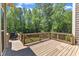Wood deck with grill overlooking wooded backyard, accessible by steps from backyard at 7304 Hasentree Club Dr, Wake Forest, NC 27587