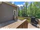 Wood deck with grill, small steps to the door, and wooded back yard at 7304 Hasentree Club Dr, Wake Forest, NC 27587