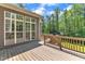 Back deck with wood railing showing the rear exterior of the house and wooded backyard at 7304 Hasentree Club Dr, Wake Forest, NC 27587