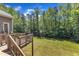A spacious deck overlooks a large, well-maintained backyard with lush greenery and mature trees, perfect for outdoor entertaining at 7304 Hasentree Club Dr, Wake Forest, NC 27587