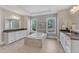 Luxurious bathroom with a central soaking tub, dual vanities, and ample natural light, creating a spa-like experience at 7304 Hasentree Club Dr, Wake Forest, NC 27587