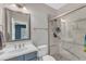 Bathroom showcasing marble countertops and a shower-tub combination with glass doors at 7304 Hasentree Club Dr, Wake Forest, NC 27587