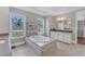 Elegant bathroom featuring a freestanding tub, dual sinks, and serene views, offering a tranquil retreat at 7304 Hasentree Club Dr, Wake Forest, NC 27587