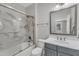 Bathroom showcasing marble countertops and a shower-tub combination with glass doors at 7304 Hasentree Club Dr, Wake Forest, NC 27587