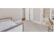 Bright bedroom featuring soft carpet, a bed, and an ensuite bathroom with marble accents at 7304 Hasentree Club Dr, Wake Forest, NC 27587