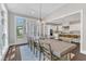 This dining room has natural light, a table with seating, and is open to the kitchen at 7304 Hasentree Club Dr, Wake Forest, NC 27587