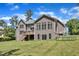 Rear view of a home features a backyard, deck, lawnmower and trampoline, providing great space for relaxing and entertaining at 7304 Hasentree Club Dr, Wake Forest, NC 27587