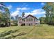 Spacious home exterior featuring a deck, multiple windows, and a well-maintained backyard at 7304 Hasentree Club Dr, Wake Forest, NC 27587
