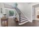 Inviting foyer features a staircase, hardwood floors, and natural light at 7304 Hasentree Club Dr, Wake Forest, NC 27587