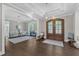 Stunning foyer features hardwood floors, stylish light fixture, and an open layout with a piano visible in the background at 7304 Hasentree Club Dr, Wake Forest, NC 27587