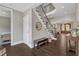 Welcoming foyer with hardwood floors, staircase, and charming decor at 7304 Hasentree Club Dr, Wake Forest, NC 27587