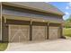 Spacious three-car garage with modern doors and ample parking space, enhancing the home's curb appeal and functionality at 7304 Hasentree Club Dr, Wake Forest, NC 27587