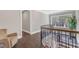 Second-floor hallway with natural light, wood floors, and wrought iron banister at 7304 Hasentree Club Dr, Wake Forest, NC 27587