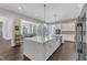 Open-concept kitchen with a large island, quartz countertops, and sleek design at 7304 Hasentree Club Dr, Wake Forest, NC 27587