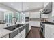This is a white kitchen with a large stainless steel sink and faucet at 7304 Hasentree Club Dr, Wake Forest, NC 27587