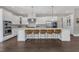 Spacious kitchen featuring a large island with barstool seating and modern appliances at 7304 Hasentree Club Dr, Wake Forest, NC 27587