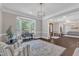 Bright living room boasting a piano, bay window and refined decor at 7304 Hasentree Club Dr, Wake Forest, NC 27587
