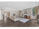 Open-concept living room with fireplace, neutral colors, and wood floors throughout at 7304 Hasentree Club Dr, Wake Forest, NC 27587