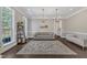 Inviting living room with dark wood floors, neutral-toned furniture, decorative shelving, and ample natural light at 7304 Hasentree Club Dr, Wake Forest, NC 27587