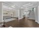 Open-concept living area with dark wood floors, multiple seating areas, and a staircase leading to the second floor at 7304 Hasentree Club Dr, Wake Forest, NC 27587