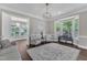 Sunlit living room featuring a piano, stylish seating, rug, and bay windows at 7304 Hasentree Club Dr, Wake Forest, NC 27587