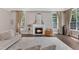 Bright living room showcases a fireplace, detailed molding and elegant furnishings at 7304 Hasentree Club Dr, Wake Forest, NC 27587