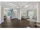 Spacious living area with dark wood flooring, an open layout, and natural light throughout at 7304 Hasentree Club Dr, Wake Forest, NC 27587