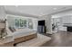 A spacious main bedroom with hardwood floors, large windows, and recessed lighting at 7304 Hasentree Club Dr, Wake Forest, NC 27587
