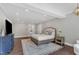 Well-lit main bedroom with a comfortable bed, dark wood floors, and modern accents, creating a serene retreat at 7304 Hasentree Club Dr, Wake Forest, NC 27587