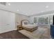 Spacious main bedroom with hardwood floors, a large window, and neutral décor, perfect for relaxation at 7304 Hasentree Club Dr, Wake Forest, NC 27587