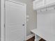 Mudroom includes storage bench, shelf, and coat hooks, and access to outdoor entrance at 7304 Hasentree Club Dr, Wake Forest, NC 27587