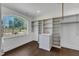 Spacious walk-in closet features custom shelving, a window, and hardwood floors at 7304 Hasentree Club Dr, Wake Forest, NC 27587