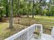Well-maintained backyard featuring a wooden fence and lush greenery, accessible from a white deck at 7405 Chickadee Ct, Sanford, NC 27332