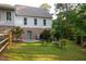 Private backyard featuring a patio area with outdoor seating, set amidst lush greenery and landscaping at 7405 Chickadee Ct, Sanford, NC 27332