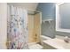 Bathroom with a shower/tub combo and floral shower curtain at 7405 Chickadee Ct, Sanford, NC 27332