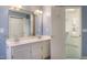 Bright bathroom with a double sink vanity and closet featuring blue accent wall at 7405 Chickadee Ct, Sanford, NC 27332