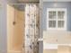 Bathroom featuring a tub and shower combination with blue floral shower curtain at 7405 Chickadee Ct, Sanford, NC 27332