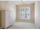 Bright bedroom featuring a large window with plantation shutters and a white armoire at 7405 Chickadee Ct, Sanford, NC 27332