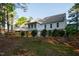Rear exterior view of the home featuring a deck and fenced-in yard, complemented by mature trees at 7405 Chickadee Ct, Sanford, NC 27332