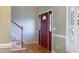Foyer featuring hardwood floors, a staircase and a red front door with decorative glass at 7405 Chickadee Ct, Sanford, NC 27332