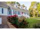 Charming home featuring a brick foundation, dormer windows, blue shutters and walkway up to the front door at 7405 Chickadee Ct, Sanford, NC 27332